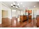 View of kitchen island, wood cabinets, stainless appliances and fixtures, with view of living room, dining room and entrance at 189 Privet Cir, Suwanee, GA 30024