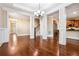 Open-concept living room with hardwood floors, white trim, and a view into the kitchen at 189 Privet Cir, Suwanee, GA 30024
