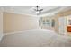 Large main bedroom with three large windows and neutral-colored carpeted floors at 189 Privet Cir, Suwanee, GA 30024