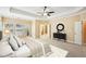 Spacious main bedroom with a tray ceiling, fan, large bed and three windows at 189 Privet Cir, Suwanee, GA 30024
