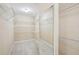 Spacious walk-in closet featuring multiple shelves and a full length dressing mirror at 189 Privet Cir, Suwanee, GA 30024