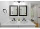 Beautiful bathroom featuring double sinks, neutral paint, modern fixtures, and plenty of natural light at 2349 Echo Cliff Ne Ct, Atlanta, GA 30345