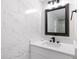 Beautiful bathroom vanity features quartz counters, modern fixtures, and marble tile at 2349 Echo Cliff Ne Ct, Atlanta, GA 30345