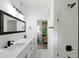 Bright bathroom featuring double vanity, modern fixtures, and a glass-enclosed shower at 2349 Echo Cliff Ne Ct, Atlanta, GA 30345