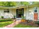 Charming home exterior boasts a well-manicured lawn, brick pathway, and painted brick at 2349 Echo Cliff Ne Ct, Atlanta, GA 30345