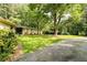 A spacious front yard with a concrete driveway and mature landscaping leading to a charming home at 2349 Echo Cliff Ne Ct, Atlanta, GA 30345