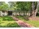 Charming home featuring mature trees, a brick pathway, and landscaped front yard at 2349 Echo Cliff Ne Ct, Atlanta, GA 30345