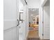 Hallway with hardwood floors leads to rooms with bright, white walls and modern, colorful decor at 2349 Echo Cliff Ne Ct, Atlanta, GA 30345