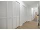 Hallway featuring wood-look floors, closet doors and a view to an open door at the end of the hall at 2349 Echo Cliff Ne Ct, Atlanta, GA 30345
