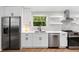 Modern kitchen with white cabinets, stainless steel appliances, and black hardware at 2349 Echo Cliff Ne Ct, Atlanta, GA 30345