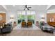 Bright living room features modern furnishings, gray couches, ceiling fan, and outdoor patio view at 2349 Echo Cliff Ne Ct, Atlanta, GA 30345