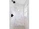 Gorgeous shower is tiled with marble and features updated fixtures and a rain shower head at 2349 Echo Cliff Ne Ct, Atlanta, GA 30345