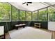 Bright sunroom featuring walls of windows, wood floors, and a comfortable seating area at 2349 Echo Cliff Ne Ct, Atlanta, GA 30345