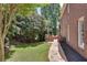 Brick home featuring a stone walkway leading to an outdoor seating area and grill at 255 Wembley Cir, Atlanta, GA 30328