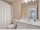 Cozy bathroom featuring a toilet, sink with white cabinets, and a shower with white curtain at 255 Wembley Cir, Atlanta, GA 30328