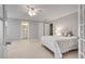 Spacious bedroom with light carpet, white doors, and a glimpse into the en-suite bathroom at 255 Wembley Cir, Atlanta, GA 30328