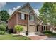 Stunning exterior view featuring a brick and stone facade, a two-car garage, and a well-manicured lawn at 255 Wembley Cir, Atlanta, GA 30328