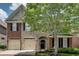 Lovely home showcasing brick and stone exterior with black shutters and a neatly landscaped front yard at 255 Wembley Cir, Atlanta, GA 30328