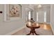 Bright and airy foyer with hardwood floors, stylish table, and niche for artwork display at 255 Wembley Cir, Atlanta, GA 30328