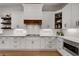 Modern kitchen with white cabinetry, stone countertops, and stainless steel microwave and oven at 255 Wembley Cir, Atlanta, GA 30328