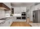 Renovated kitchen with stainless steel appliances and modern white cabinetry with stone countertops at 255 Wembley Cir, Atlanta, GA 30328
