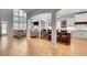 Open floor plan with kitchen island flowing into the living room with large windows and built ins at 255 Wembley Cir, Atlanta, GA 30328