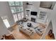 Bright living room with hardwood floors, tall windows, and a fireplace with built-in shelving at 255 Wembley Cir, Atlanta, GA 30328