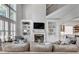 Bright living room featuring a fireplace, built-in shelves, large windows, and comfortable seating at 255 Wembley Cir, Atlanta, GA 30328