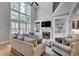 Spacious living room with soaring ceilings, fireplace, built-in shelves, and large windows at 255 Wembley Cir, Atlanta, GA 30328