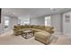 Spacious living room featuring a large sectional sofa, neutral carpeting, and a modern coffee table at 255 Wembley Cir, Atlanta, GA 30328