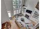 Bright living room with hardwood floors, tall windows, and a fireplace with built-in shelving at 255 Wembley Cir, Atlanta, GA 30328