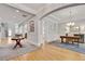 Open-concept living space with hardwood floors, connecting the foyer to the living room and office at 255 Wembley Cir, Atlanta, GA 30328