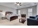 Serene main bedroom with tray ceilings, neutral tones, and a sitting area at 255 Wembley Cir, Atlanta, GA 30328