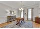 Bright office space featuring hardwood floors, stylish chandelier, and a large wooden desk with decor at 255 Wembley Cir, Atlanta, GA 30328