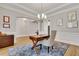 Bright office with hardwood floors, blue rug, stylish chair, and wood desk at 255 Wembley Cir, Atlanta, GA 30328