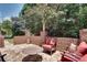 Private brick patio with stone flooring and comfortable outdoor seating surrounded by greenery at 255 Wembley Cir, Atlanta, GA 30328