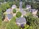 Aerial view of a home on a cul-de-sac surrounded by lush greenery and mature trees at 302 Shawnee Indian Ln, Suwanee, GA 30024