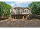 Back exterior view of home with deck and stairs leading to yard at 302 Shawnee Indian Ln, Suwanee, GA 30024