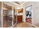 The bathroom features tile flooring, a tiled shower with a glass enclosure, and a vanity at 302 Shawnee Indian Ln, Suwanee, GA 30024