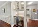 Stylish butler's pantry with custom cabinetry, granite countertops, and a wine fridge at 302 Shawnee Indian Ln, Suwanee, GA 30024