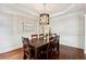 Elegant dining room with hardwood floors, decorative paneling, and a chandelier at 302 Shawnee Indian Ln, Suwanee, GA 30024