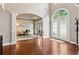 Spacious foyer with hardwood flooring, arched doorways, and a decorative glass front door at 302 Shawnee Indian Ln, Suwanee, GA 30024