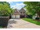 Charming brick home with well-manicured lawn and two-car garage at 302 Shawnee Indian Ln, Suwanee, GA 30024