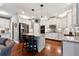 Updated kitchen with an island, stainless appliances, and white cabinets at 302 Shawnee Indian Ln, Suwanee, GA 30024