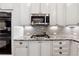 Modern kitchen with stainless steel appliances, granite counters, and under-cabinet lighting at 302 Shawnee Indian Ln, Suwanee, GA 30024