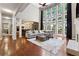 Bright living room with a fireplace, built-in shelving, and large windows with vaulted ceilings at 302 Shawnee Indian Ln, Suwanee, GA 30024