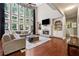 Spacious living room with a fireplace, built-in shelving, and large windows at 302 Shawnee Indian Ln, Suwanee, GA 30024