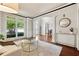 Bright living room featuring large windows, hardwood floors, and elegant trim at 302 Shawnee Indian Ln, Suwanee, GA 30024