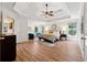 Spacious main bedroom featuring tray ceilings, a ceiling fan and wood flooring at 302 Shawnee Indian Ln, Suwanee, GA 30024