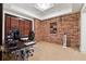 Study room featuring a brick wall, desk and great natural light at 302 Shawnee Indian Ln, Suwanee, GA 30024